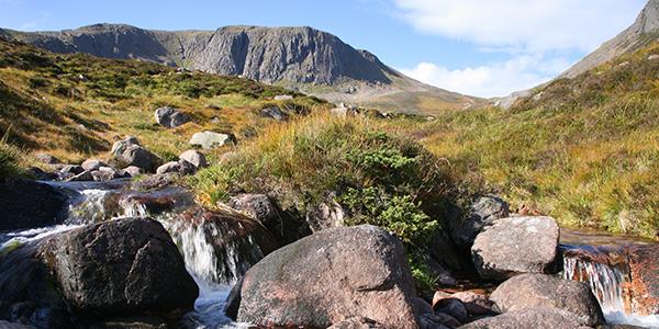 A stream flows through the spectacular scenery of Scotland's Cairngorm mountains