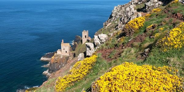 Botallack Mine sitting on the steep rugged coastline, the famous Crown engine houses cling to the rock face